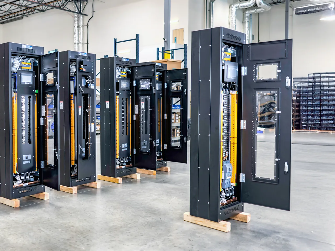 DEI remote power panels in black enclosures at DEI’s shop, doors open